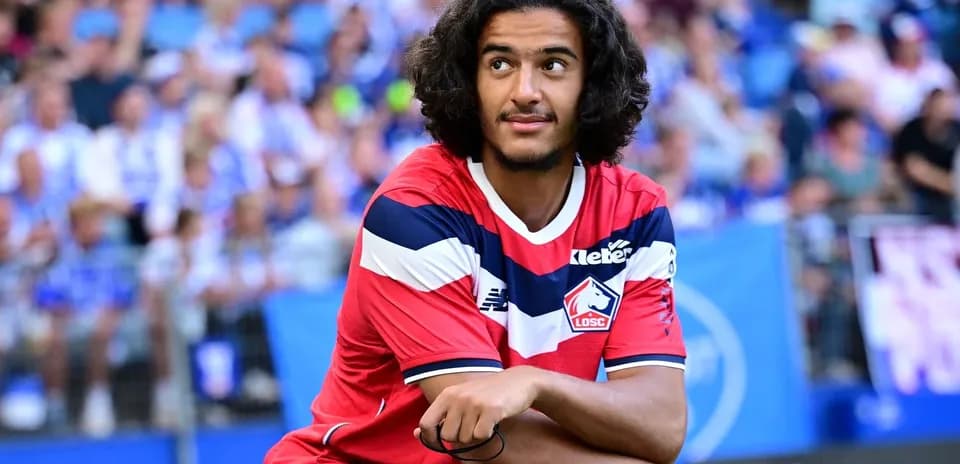 Player sitting on field during match warm-up
