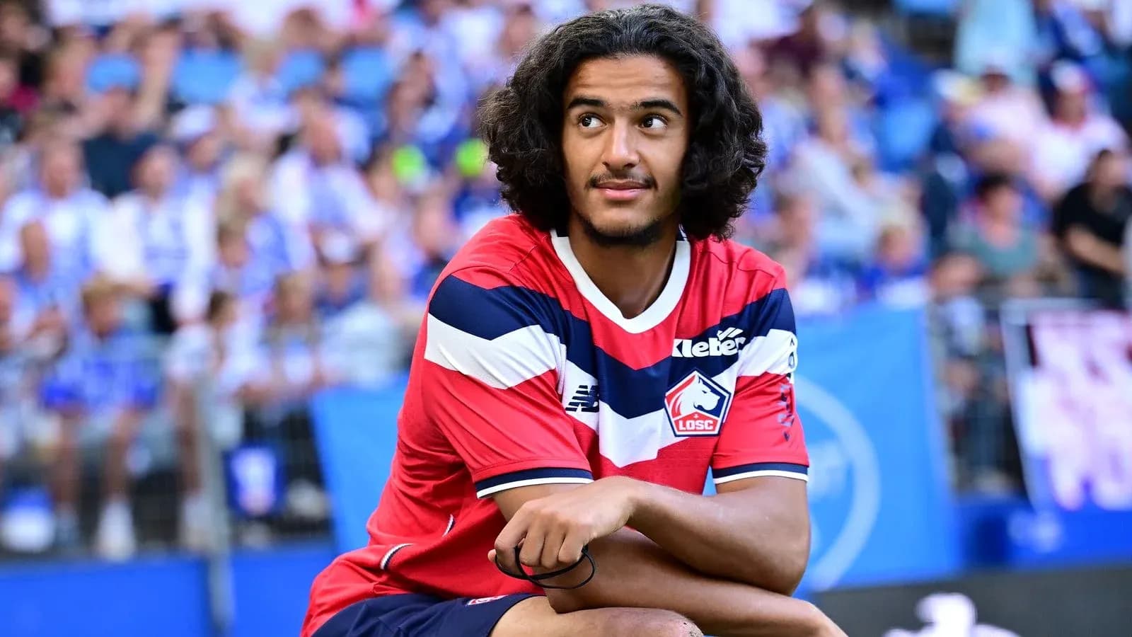 Player sitting on field during match warm-up