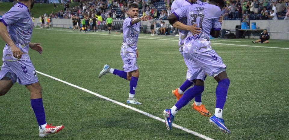 Players celebrating a goal during a football match