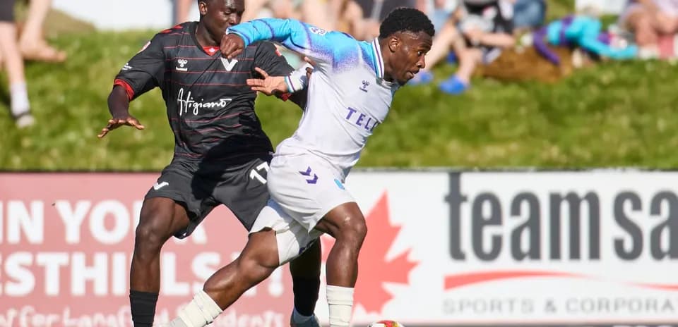Pacific FC player dribbling past Vancouver FC defender