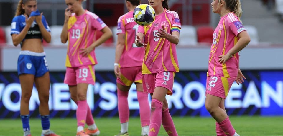Players in pink jerseys during a match on field