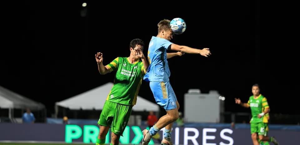 Players competing for the ball in USL match