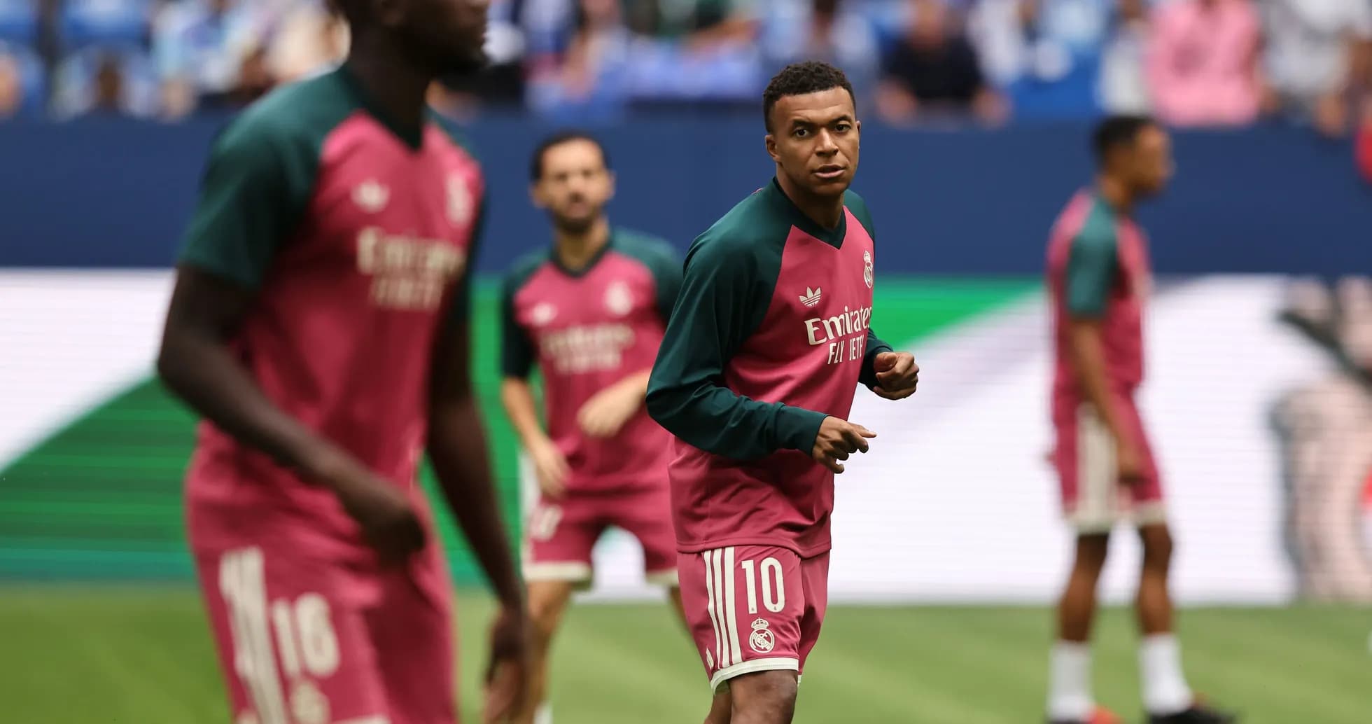 Players warming up on the pitch before match
