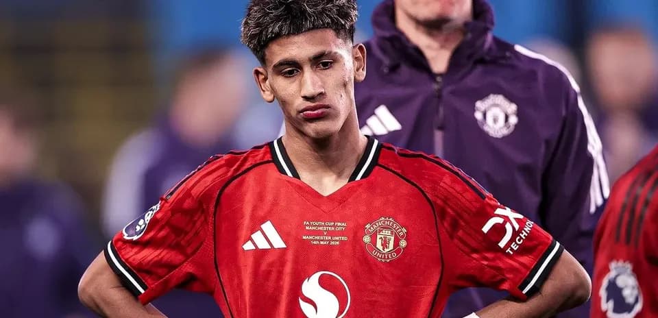 Young player in Manchester United kit looking down