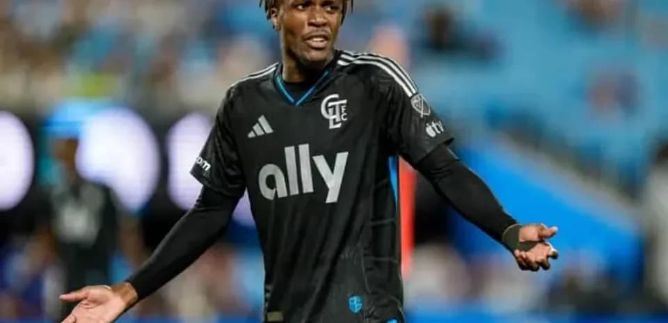 Player gesturing during match in black jersey