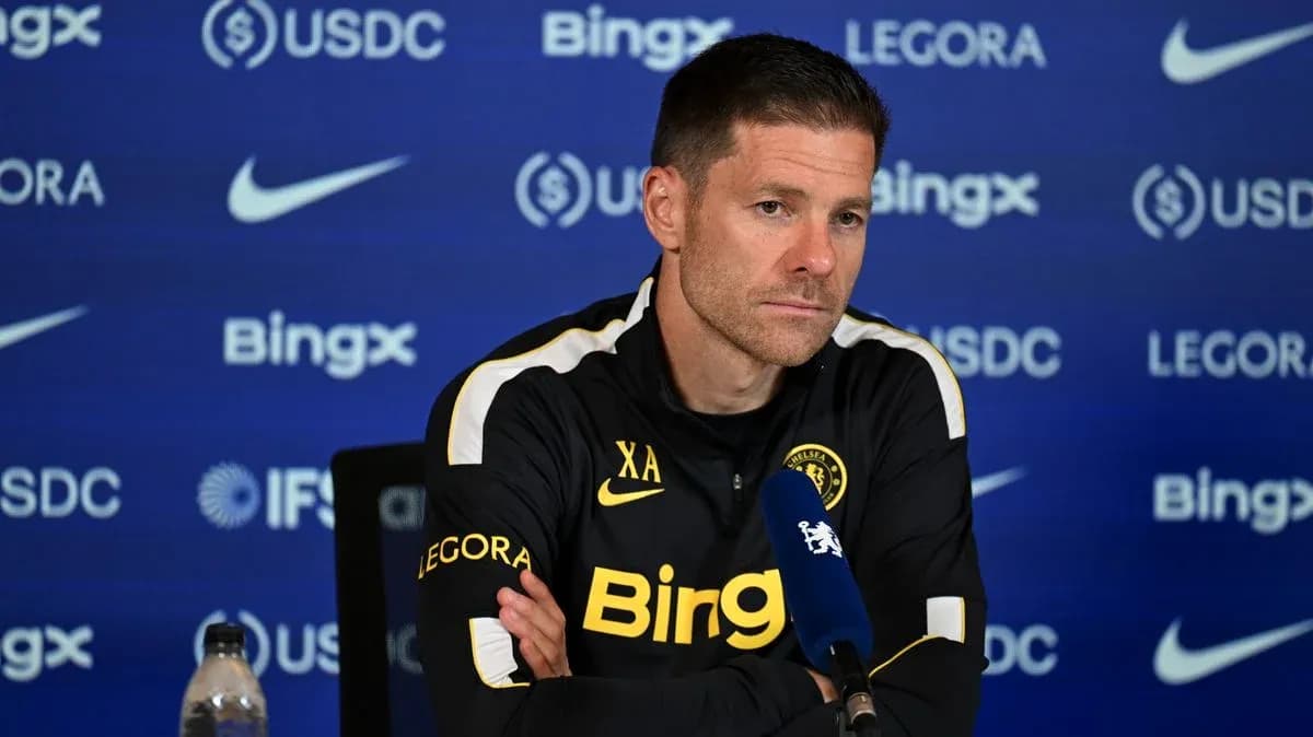 Manager at press conference with sponsor backdrop