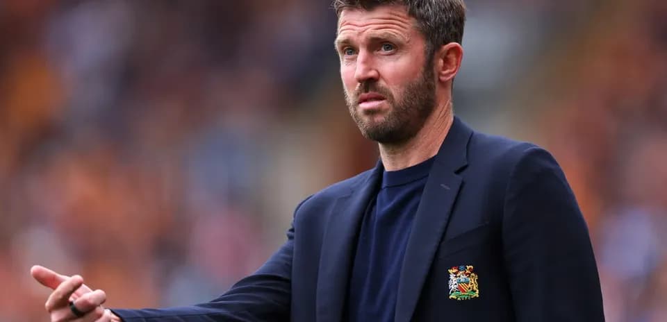 Manager gesturing during a match on the sidelines