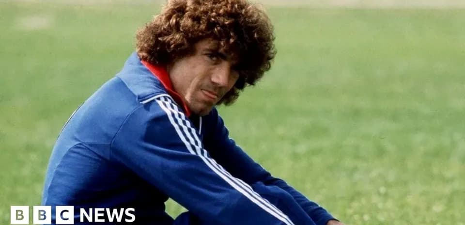 Player sitting on grass field in training gear