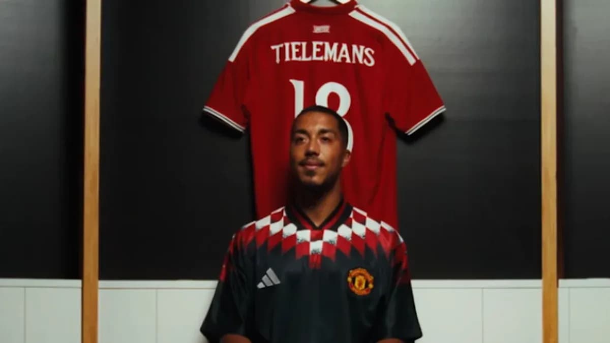 Player posing in Manchester United jersey with another jersey