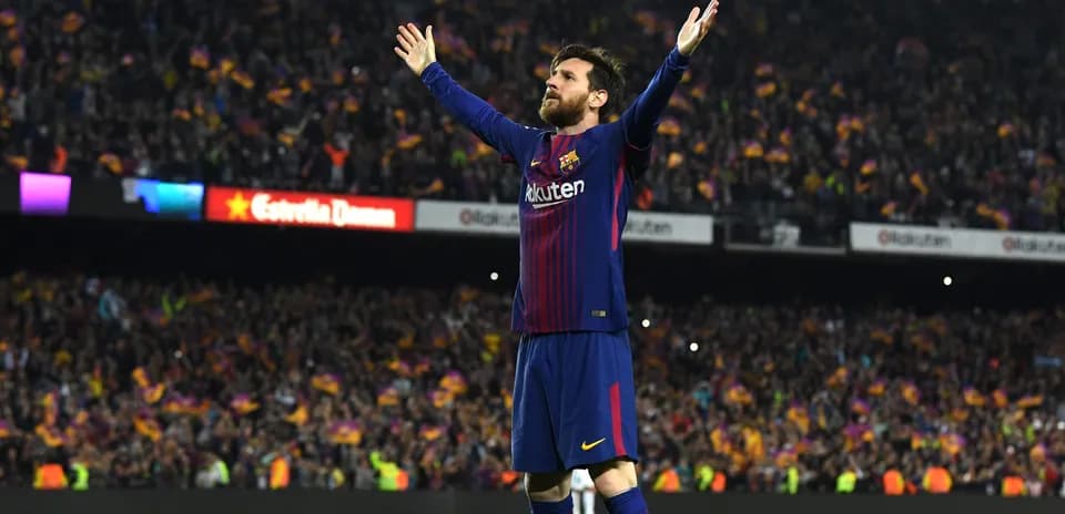 Player celebrating with arms raised at stadium