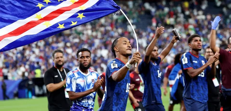 Player celebrating with Cape Verde flag after match