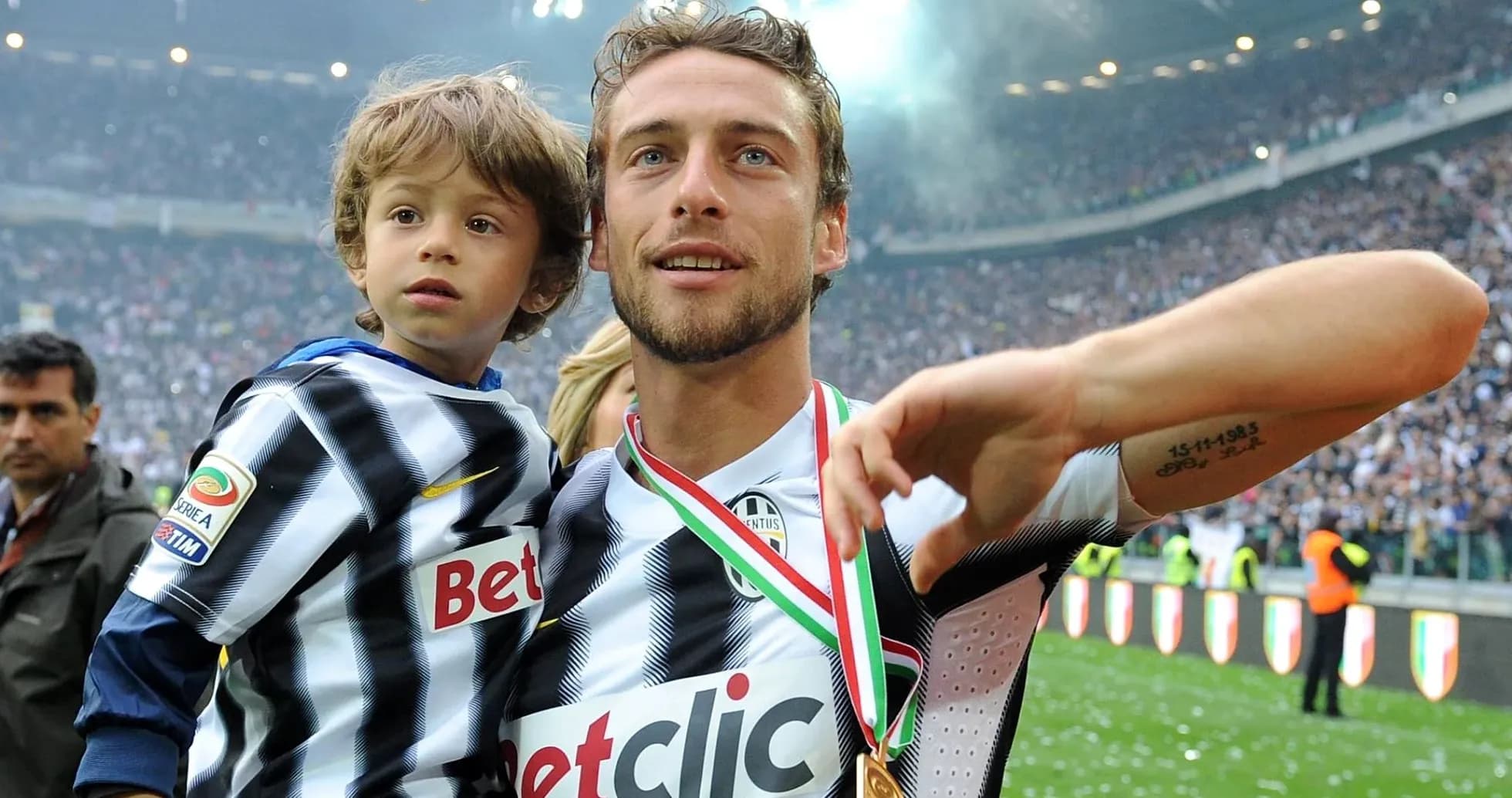Player celebrating with child after match victory