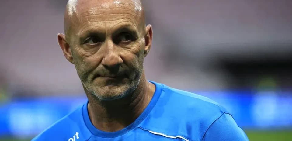 Coach in blue training kit during match preparation