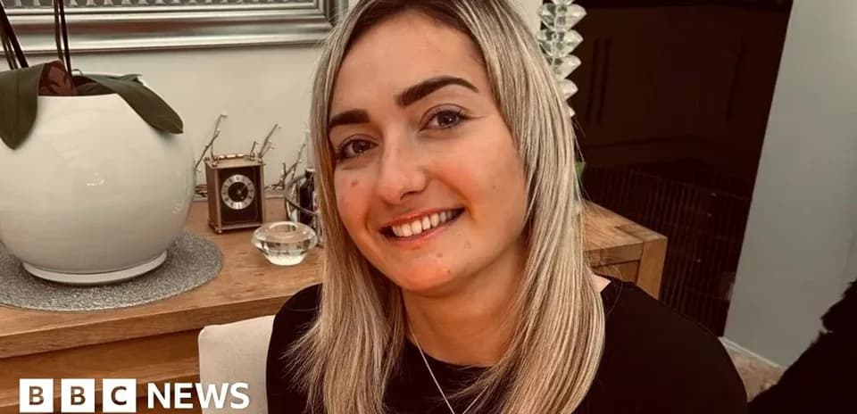 Smiling woman sitting at a wooden table