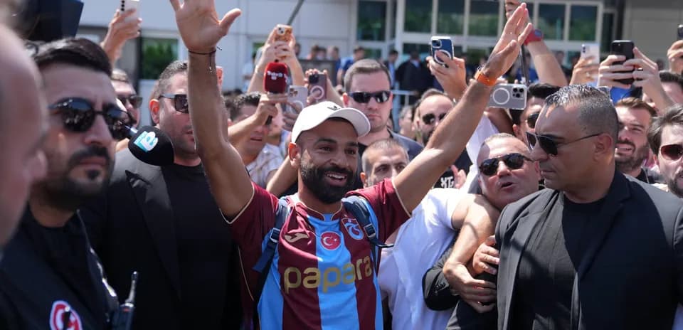 Player greeting fans while surrounded by crowd