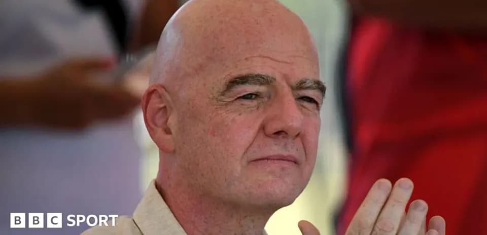 Man with bald head sitting and clasping hands