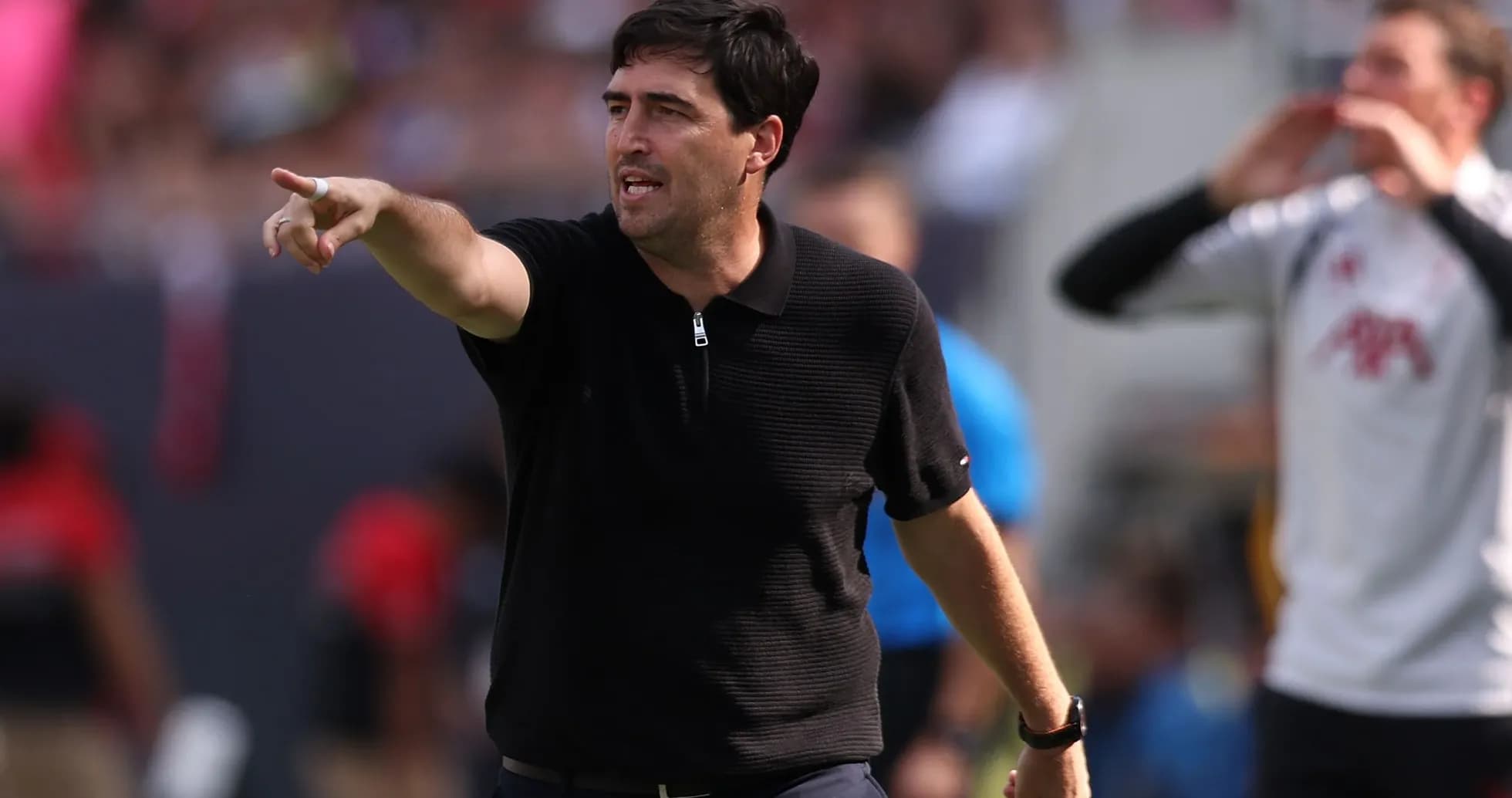 Coach directing players during a match on the sidelines