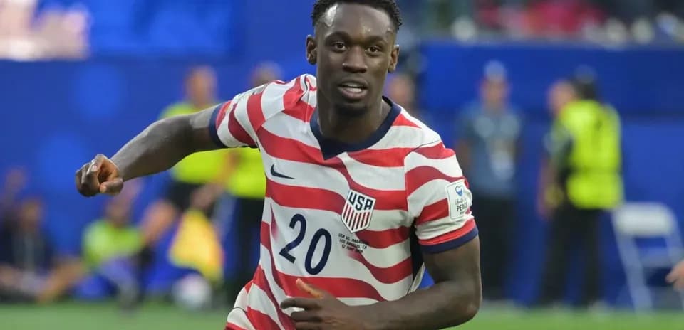 Player in USA jersey celebrating a goal