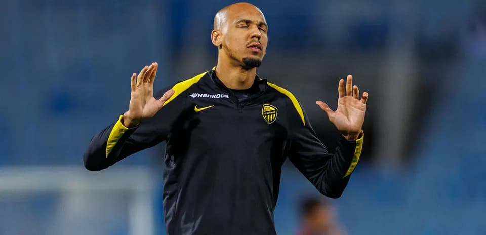 Player stretching during warm-up session on pitch