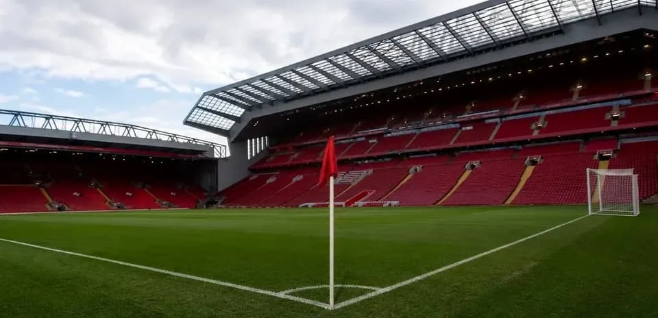 Corner flag in empty stadium with red seats