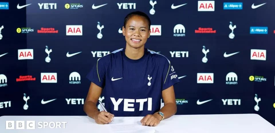 Player signing contract at Tottenham press conference