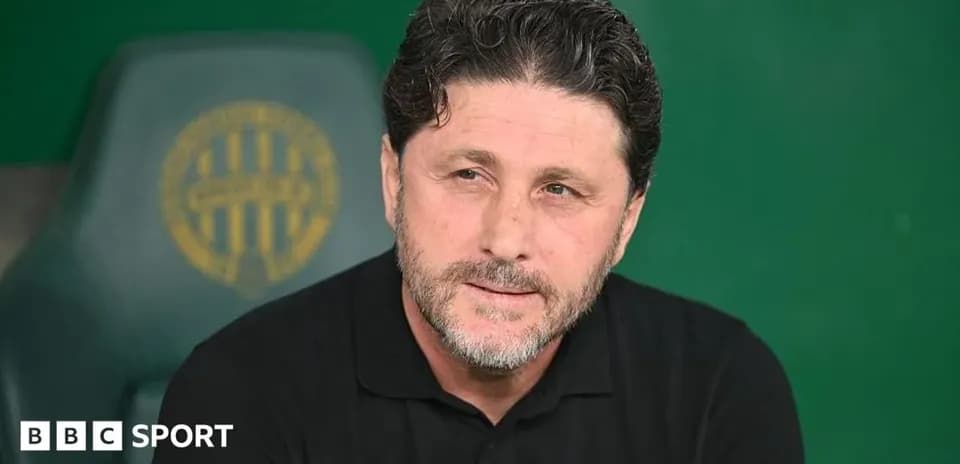 Coach sitting on bench during match preparation