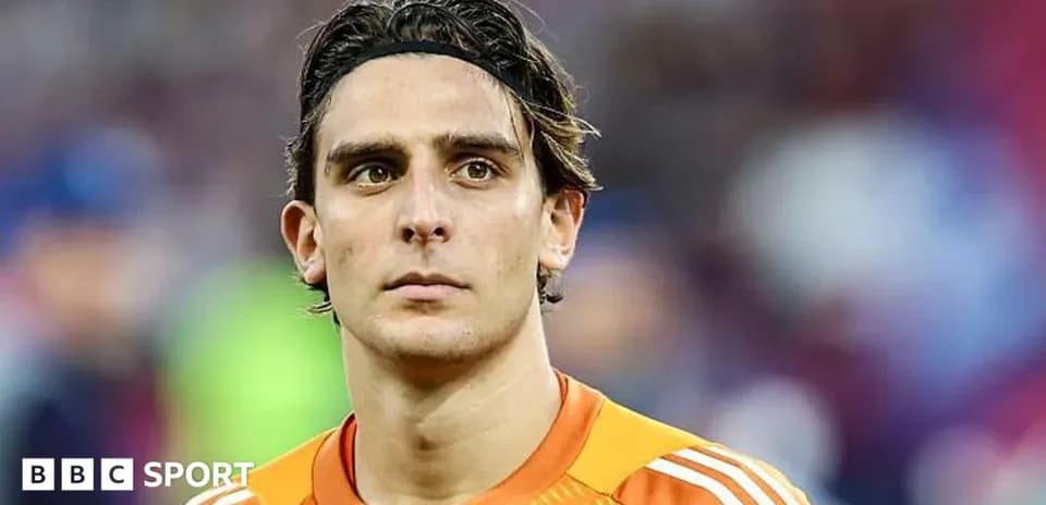 Goalkeeper in orange kit during match close-up