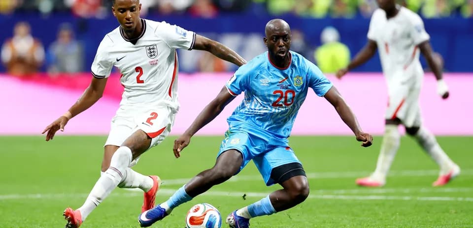 England player challenges Congo DR player for the ball