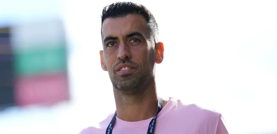 Player wearing pink shirt at stadium entrance