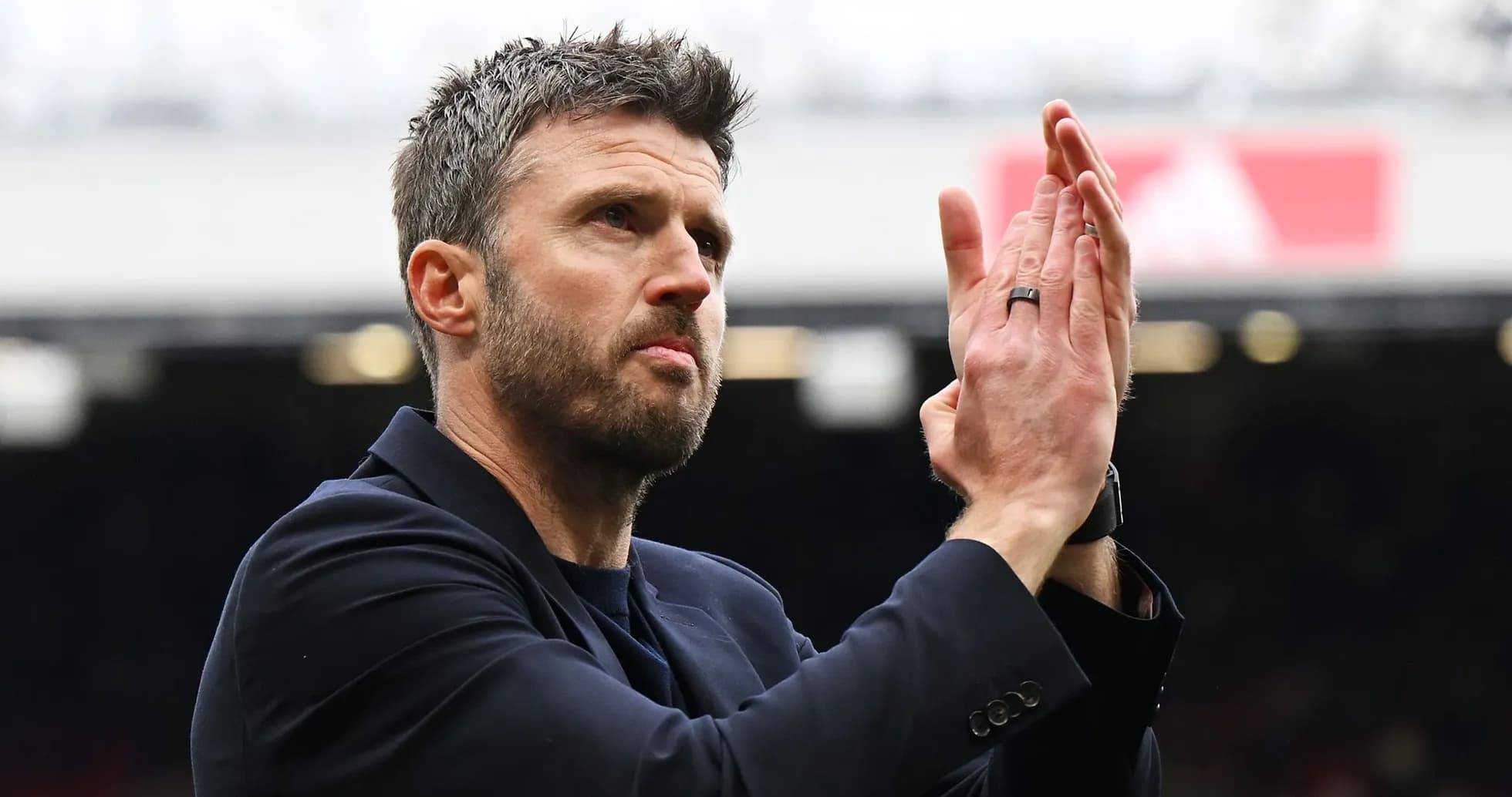 Coach applauding fans at the stadium