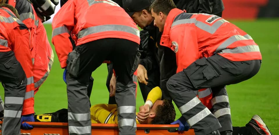 Medical team assisting injured player on stretcher