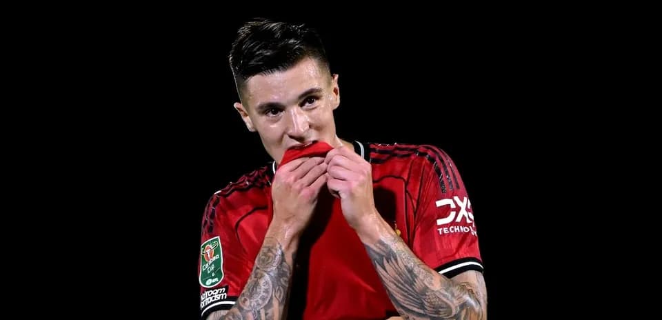 Player in red jersey holding shirt to face