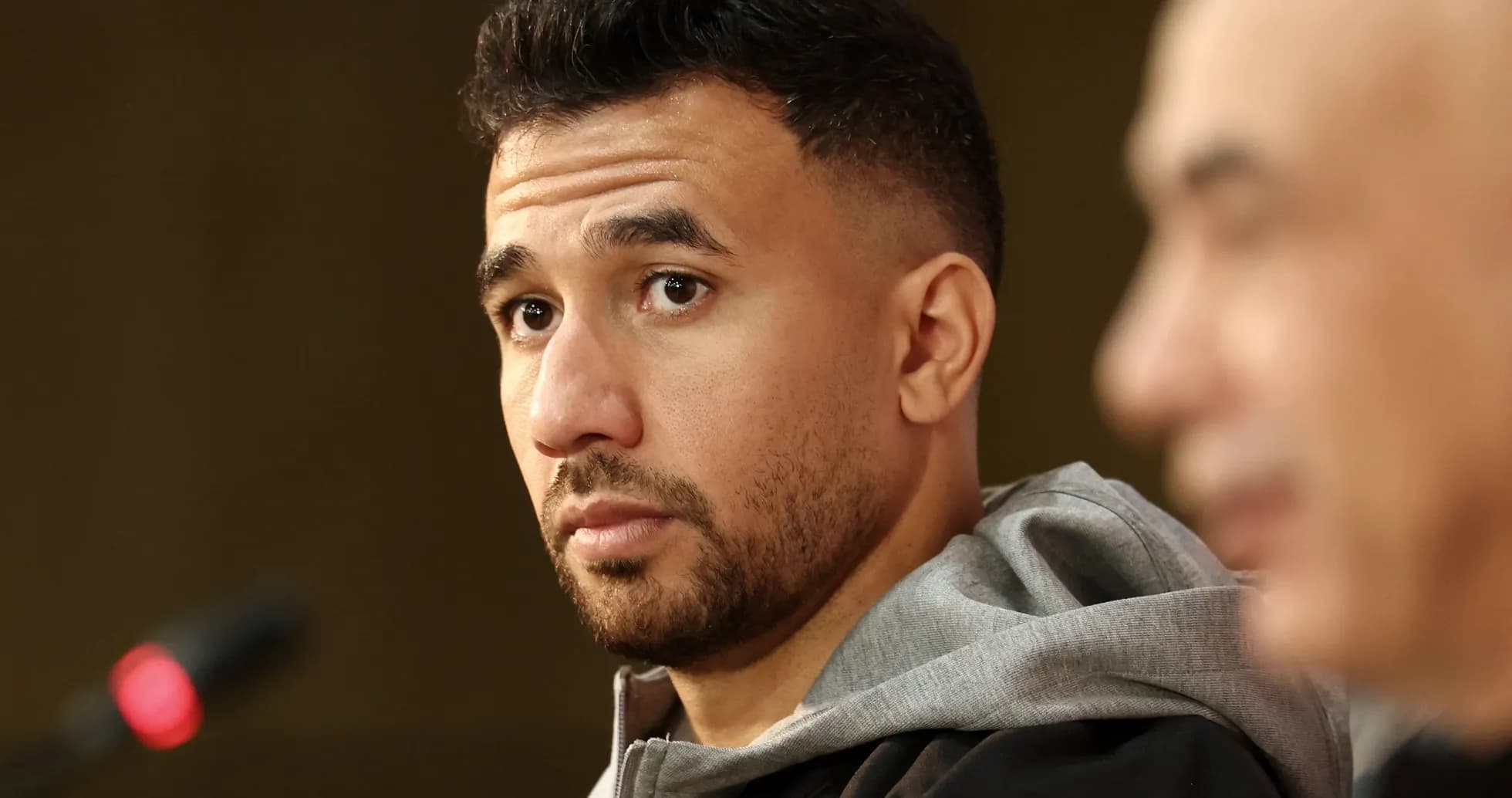 Player at press conference with microphone in foreground