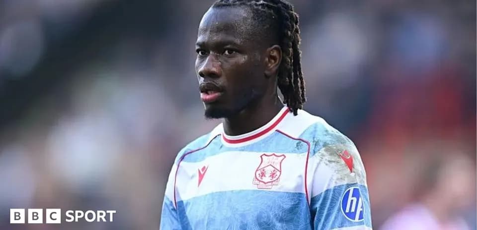 Player wearing blue and white striped jersey during match
