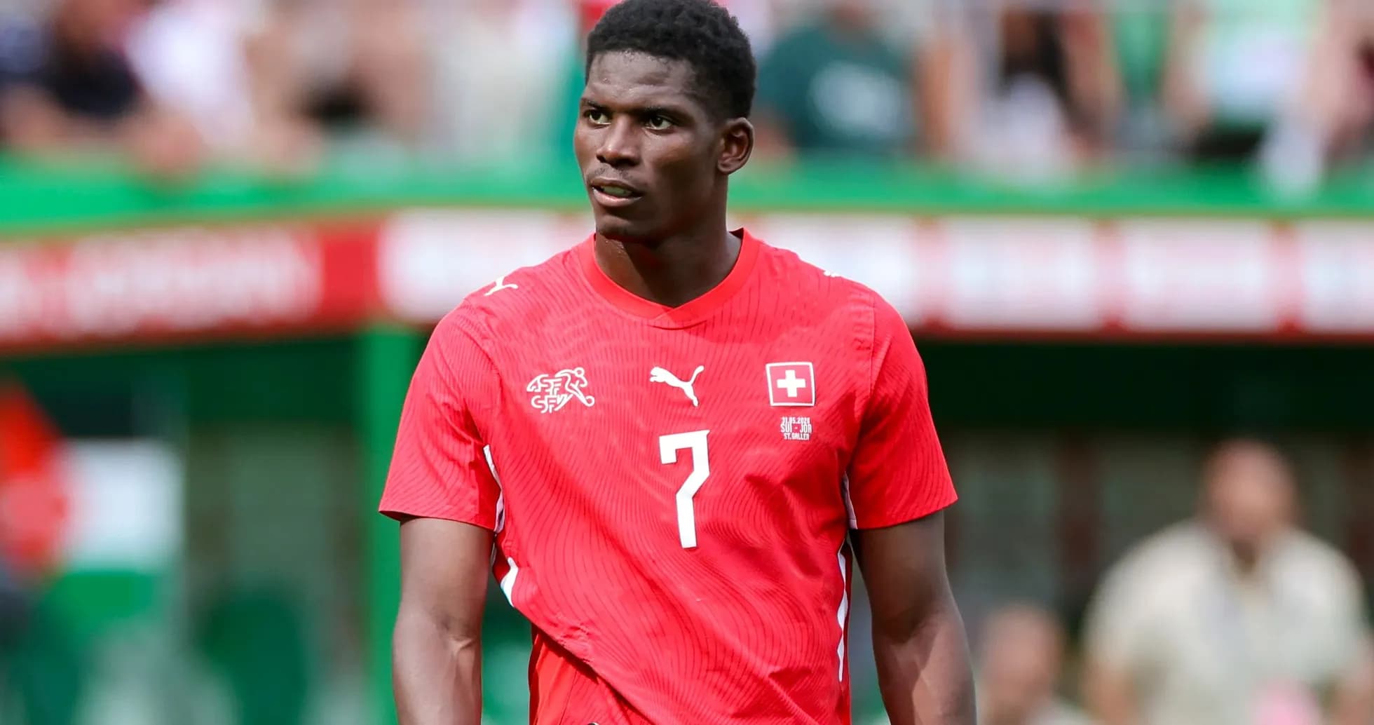 Player wearing red Switzerland jersey on the field