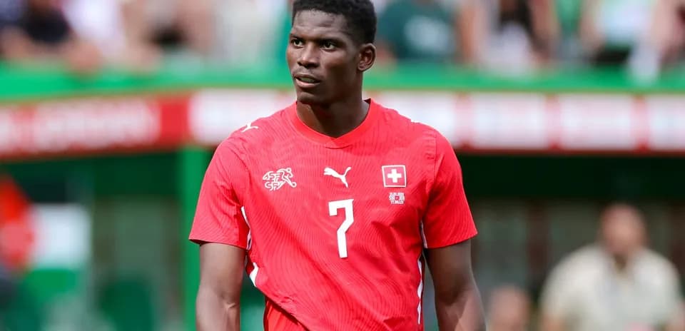Player wearing red Switzerland jersey on the field