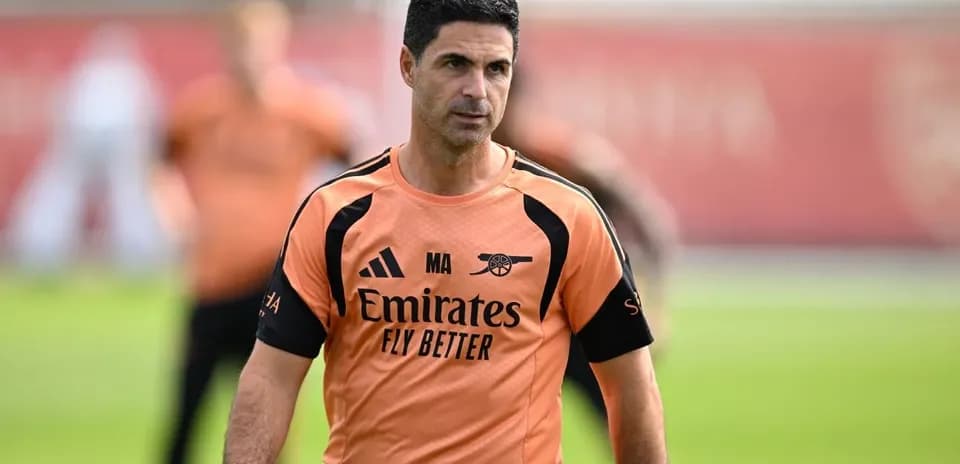 Manager walking on training pitch during session