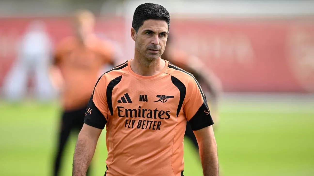 Manager walking on training pitch during session