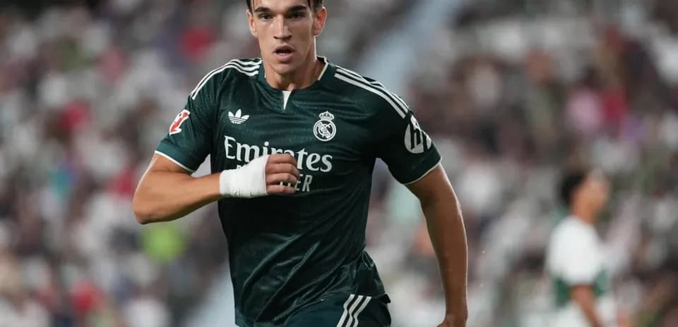 Player running in green Real Madrid jersey during match