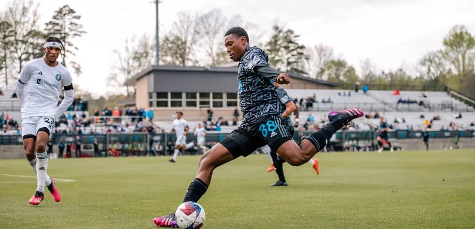 Player kicking ball during Huntsville City match
