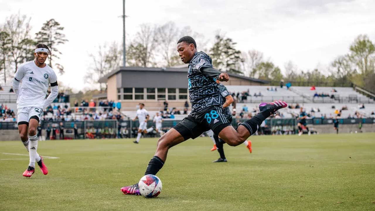 Player kicking ball during Huntsville City match