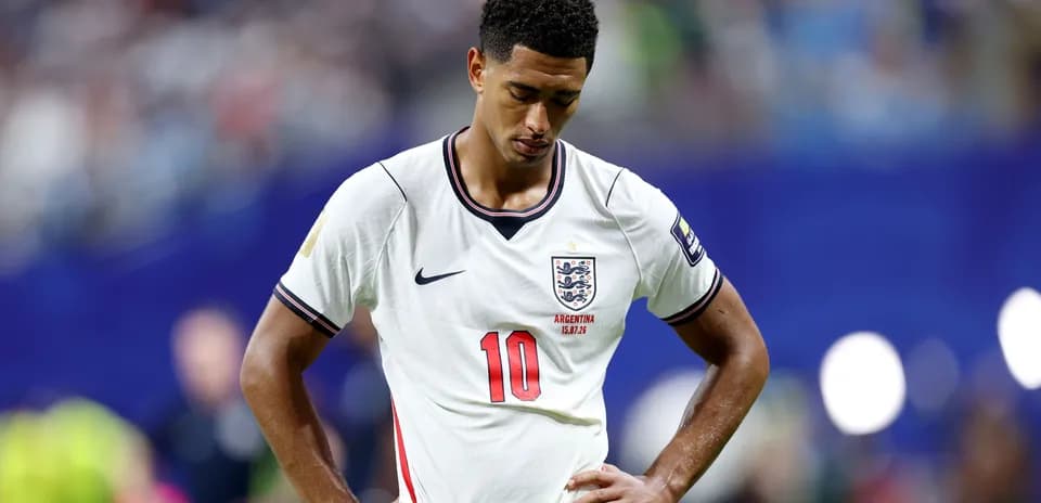 England player with head down on the pitch