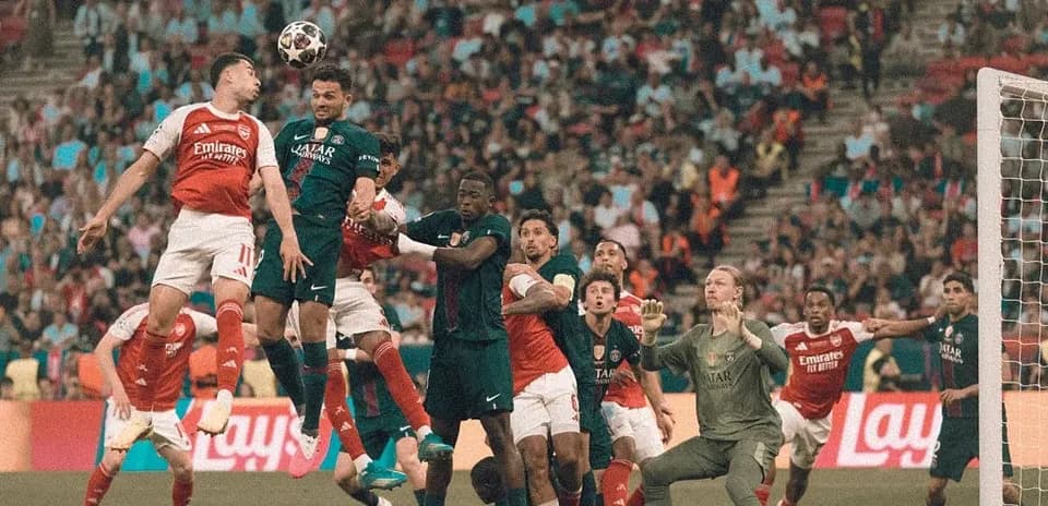 Players contesting a high ball in the penalty area