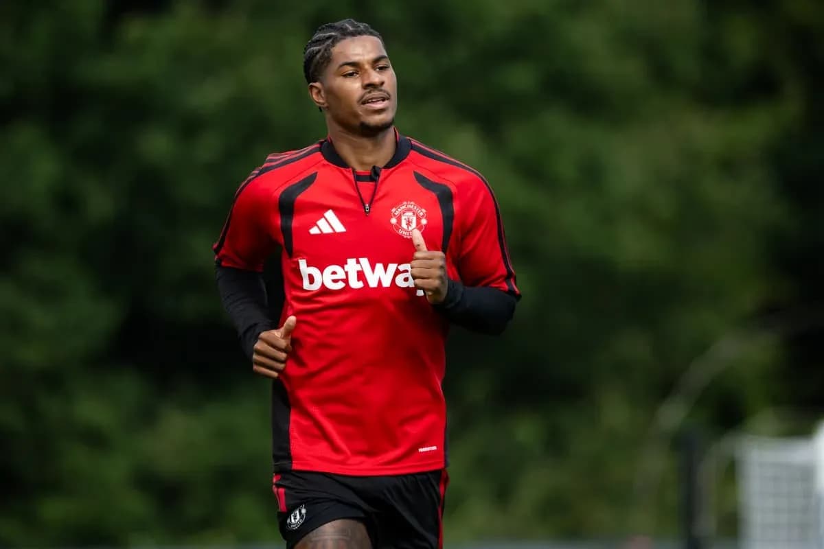 Player jogging during training session in red kit