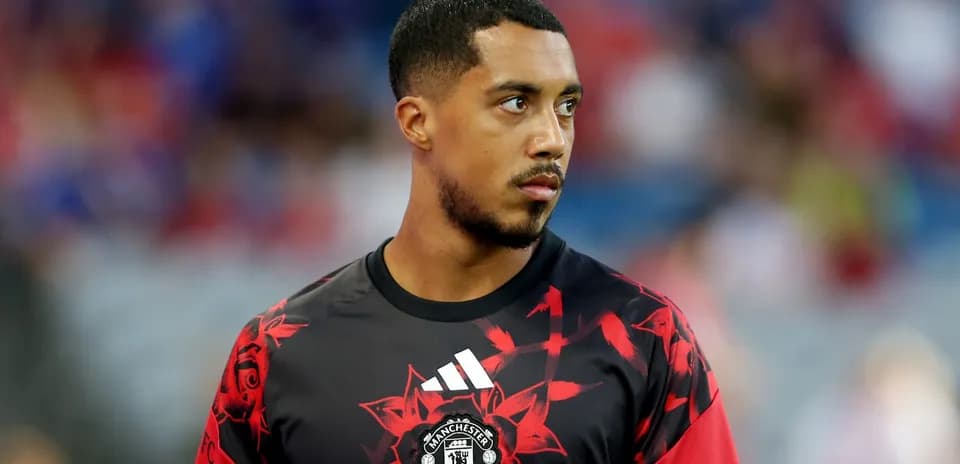 Player in Manchester United training kit on pitch