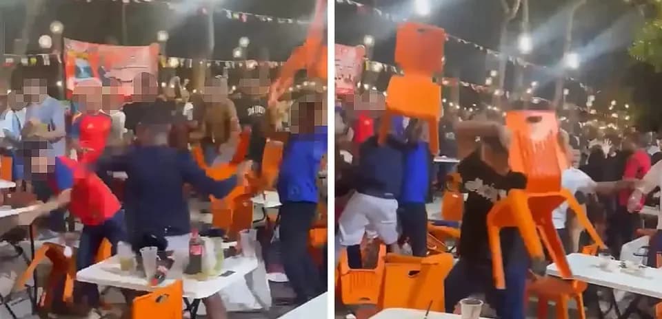 Crowd throwing chairs during a chaotic celebration
