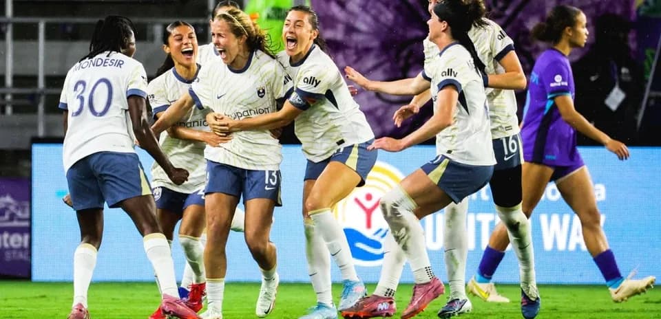 Players celebrating a goal during NWSL match