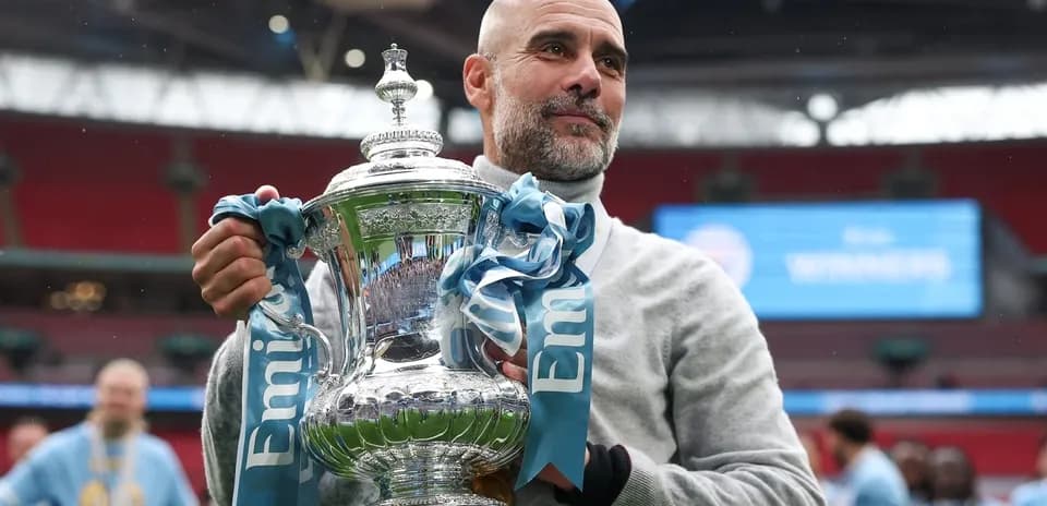 Coach holding trophy at stadium after victory