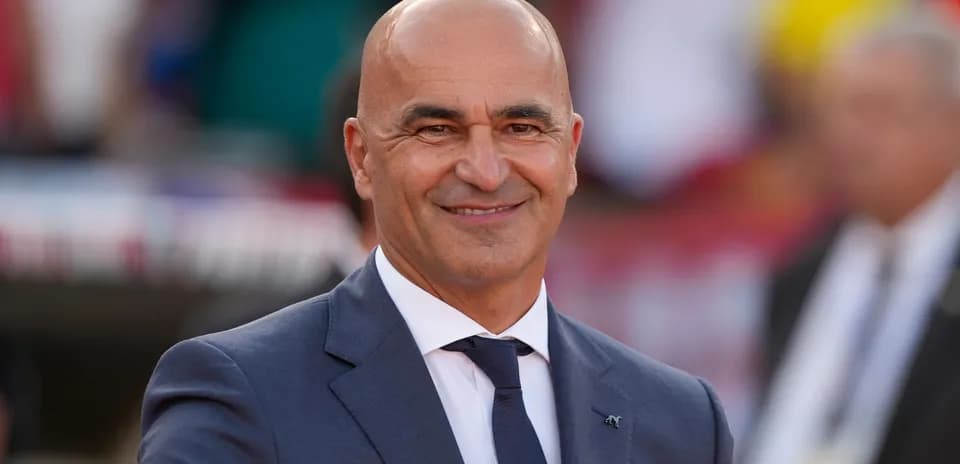 Coach smiling during match day preparations
