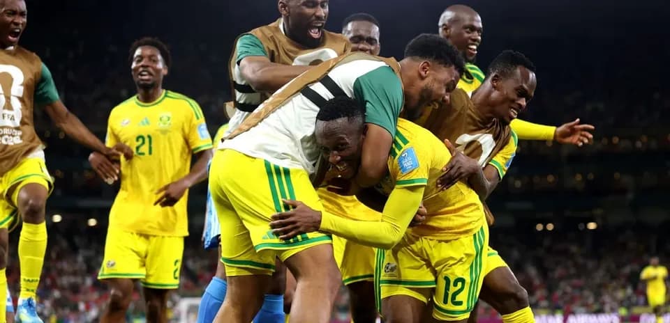 Players celebrating a goal on the field